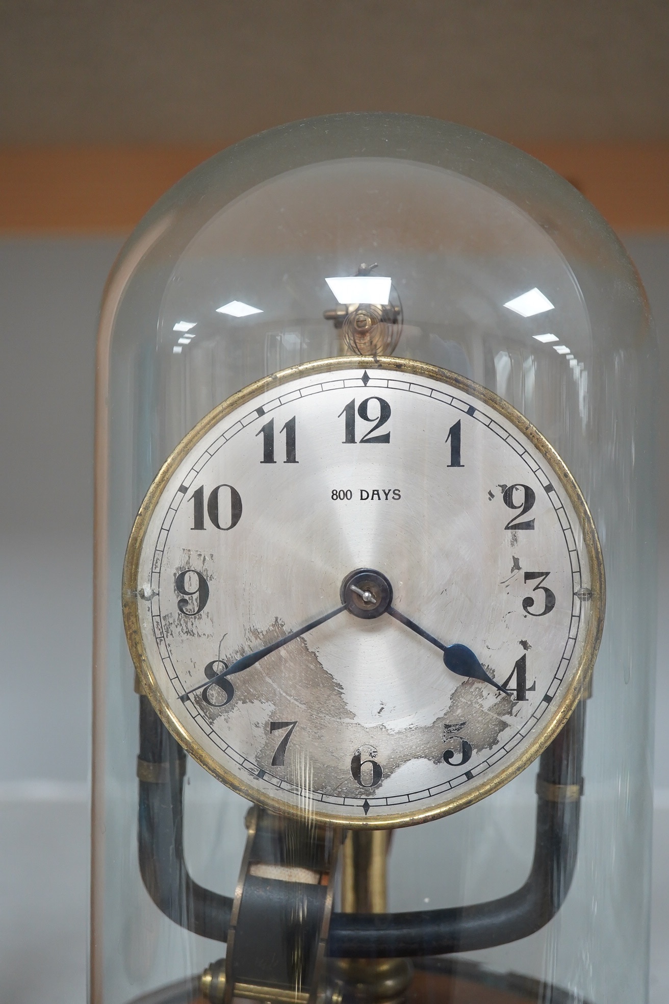 A Bulle type electric 800 day timepiece under dome, 26cm. Condition - worn, not tested